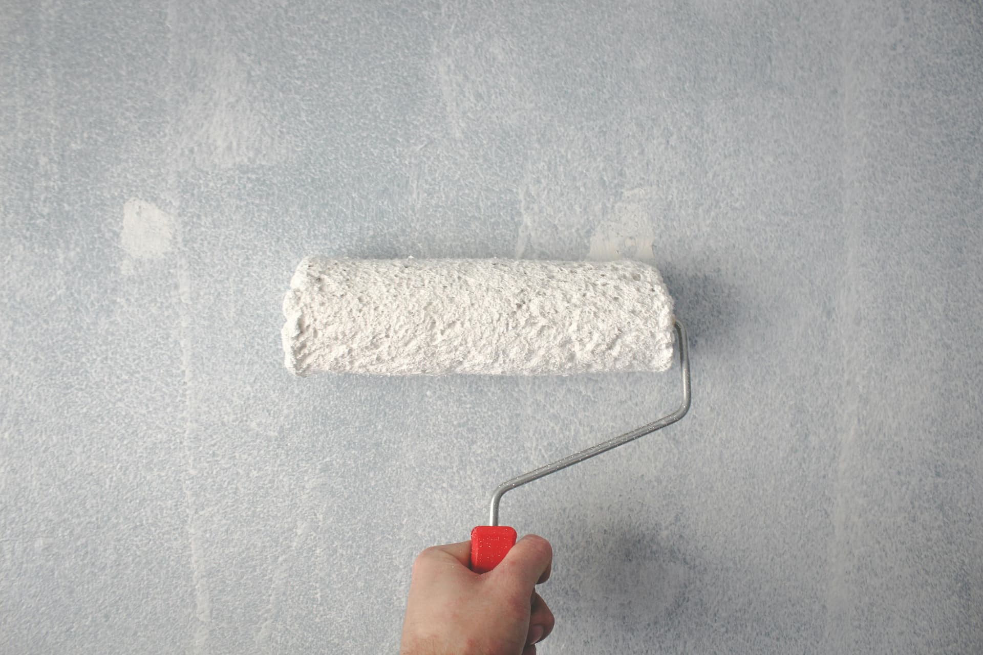 Pintor profesional pintando pared interior con rodillo en departamento de Buenos Aires - guía completa 2026